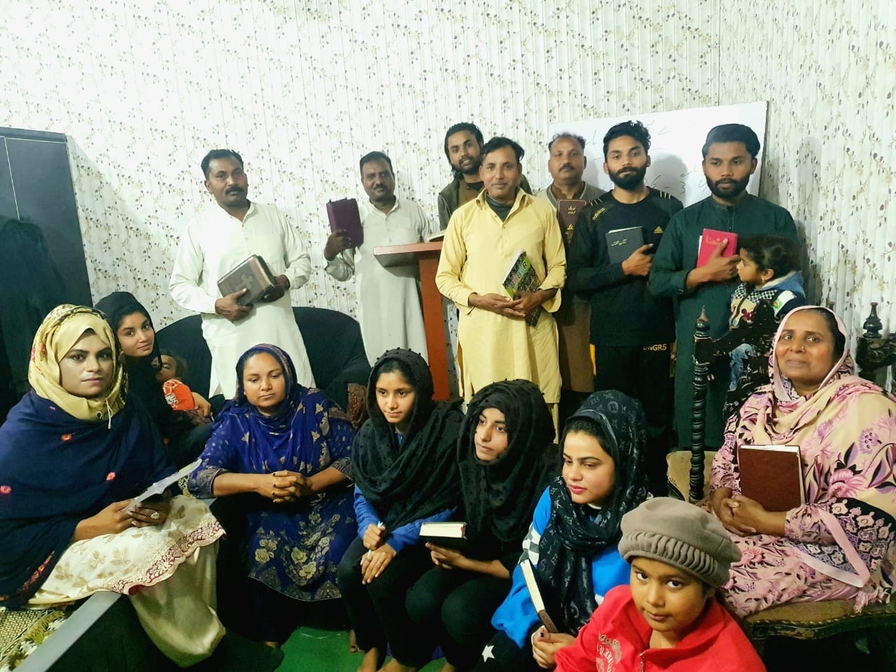 Large Bible study group gathered indoors in Pakistan