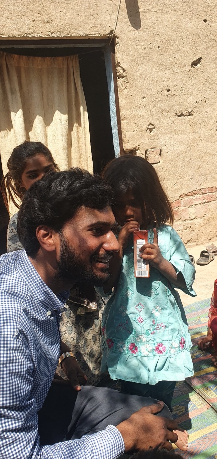 Ministry worker sharing with a young child in Pakistan
